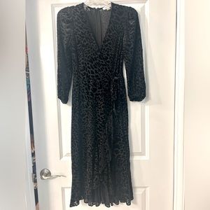 Calvin Klein long sleeve black flutter hem dress. Size 2